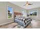 Bright bedroom featuring hardwood floors and tranquil views from multiple windows at 12000 S Highway 475, Ocala, FL 34480