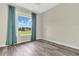 Bedroom with large window and teal curtains at 12000 S Highway 475, Ocala, FL 34480