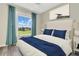 Bedroom with large window, blue bedding, and wood floor at 12000 S Highway 475, Ocala, FL 34480