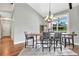 Elegant dining room featuring a live-edge wood table, chandelier, and hardwood floors at 12000 S Highway 475, Ocala, FL 34480