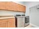 Bright laundry room with washer, dryer, and ample cabinetry at 12000 S Highway 475, Ocala, FL 34480