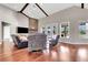 Spacious living room with hardwood floors, a stone fireplace, and comfortable leather seating at 12000 S Highway 475, Ocala, FL 34480