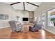 Spacious living room with hardwood floors, a stone fireplace, and comfortable leather seating at 12000 S Highway 475, Ocala, FL 34480