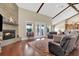 Spacious living area with hardwood floors, stone fireplace, and access to the backyard patio at 12000 S Highway 475, Ocala, FL 34480