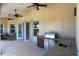 Covered patio with ceiling fans, grill, and access to the backyard at 12000 S Highway 475, Ocala, FL 34480