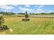 Spacious paddock with a tree in the center, ideal for horses at 12000 S Highway 475, Ocala, FL 34480