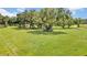 Large pasture with mature trees and wooden fencing at 12000 S Highway 475, Ocala, FL 34480