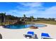 Relaxing pool area with a rock waterfall and fire pit at 12000 S Highway 475, Ocala, FL 34480