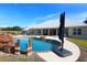 Resort-style pool with a waterfall and fire pit, near the home at 12000 S Highway 475, Ocala, FL 34480
