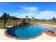 Stunning pool with a rock waterfall and fire pit, overlooking a pasture at 12000 S Highway 475, Ocala, FL 34480