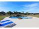 Inviting pool with a rock waterfall feature, fire pit, and lounge chairs at 12000 S Highway 475, Ocala, FL 34480