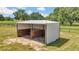 Metal run-in shed with wooden interior stalls at 12000 S Highway 475, Ocala, FL 34480