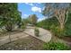 Landscaped backyard with curved patio at 2021 Se Twin Bridge Cir, Ocala, FL 34471