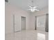 Large bedroom with tile floors and ceiling fan at 2021 Se Twin Bridge Cir, Ocala, FL 34471