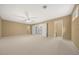 Large bedroom with carpet, ceiling fan and access to bathroom at 2021 Se Twin Bridge Cir, Ocala, FL 34471