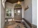 Front entry with tiled flooring, door and sidelight at 2021 Se Twin Bridge Cir, Ocala, FL 34471