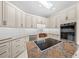 Modern kitchen with granite countertops and a cooktop island at 2021 Se Twin Bridge Cir, Ocala, FL 34471