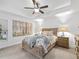 This beautiful bedroom has a ceiling fan, and a picture hanging on the wall at 205 Brevard Ave, Lady Lake, FL 32159