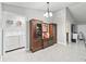 Bright dining area next to a laundry room featuring a modern chandelier and ample space at 205 Brevard Ave, Lady Lake, FL 32159