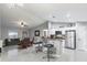 Bright living space features tile floors, a modern stainless steel refrigerator, and a breakfast bar at 205 Brevard Ave, Lady Lake, FL 32159