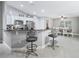 Modern kitchen with stainless steel appliances, breakfast bar, and a view to the dining area at 205 Brevard Ave, Lady Lake, FL 32159