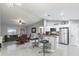 Modern kitchen with stainless steel appliances, white cabinets, and a breakfast bar at 205 Brevard Ave, Lady Lake, FL 32159