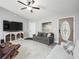 Bright living room showcases tile flooring, comfortable seating, and a decorative front door at 205 Brevard Ave, Lady Lake, FL 32159
