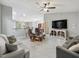 Spacious living room with tile floors, neutral paint, ceiling fan, and comfortable seating area at 205 Brevard Ave, Lady Lake, FL 32159