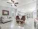 Open-concept living space featuring tile flooring, lots of seating, and a view of the kitchen at 205 Brevard Ave, Lady Lake, FL 32159