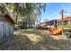 Green backyard with trees and a storage shed at 2412 Se 23Rd Pl, Ocala, FL 34471