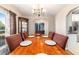 Dining room showcasing hardwood floors and a table, adjacent to kitchen and living areas at 2412 Se 23Rd Pl, Ocala, FL 34471