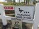 Close up of community signage indicating ducks have right of way, protected by video surveillance at 2412 Se 23Rd Pl, Ocala, FL 34471