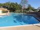 Large community pool surrounded by lush landscaping at 2412 Se 23Rd Pl, Ocala, FL 34471