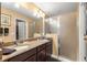 Double vanity bathroom with granite countertops and a large shower at 2997 Teasdale Ter, The Villages, FL 32163