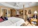 Spacious Primary bedroom with a post bed, dresser, and sitting area at 2997 Teasdale Ter, The Villages, FL 32163