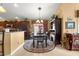 Elegant dining room with dark wood furniture and chandelier at 2997 Teasdale Ter, The Villages, FL 32163