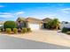 Single-story house with a two-car garage and landscaped yard at 2997 Teasdale Ter, The Villages, FL 32163