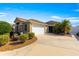 Single story home with a two-car garage and well maintained landscaping at 2997 Teasdale Ter, The Villages, FL 32163