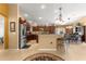 Spacious kitchen with dark wood cabinets, granite countertops, and stainless steel appliances at 2997 Teasdale Ter, The Villages, FL 32163