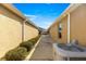 Side yard with concrete walkway and landscaping at 2997 Teasdale Ter, The Villages, FL 32163