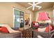 Relaxing sunroom with wicker furniture and sliding glass doors at 2997 Teasdale Ter, The Villages, FL 32163