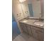 Bathroom featuring double sinks, granite countertops, and modern fixtures at 3168 Ne 46Th Ave, Ocala, FL 34470