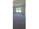 Bedroom featuring plush carpeting and a bright window offering ample natural light at 3168 Ne 46Th Ave, Ocala, FL 34470