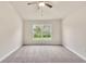 Large main bedroom with carpeted floor and ceiling fan at 3168 Ne 46Th Ave, Ocala, FL 34470