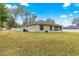 Large backyard with grassy area and side view of home at 3707 Se 24Th St, Ocala, FL 34471