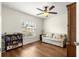 Bright bedroom with hardwood floors, large window, and ceiling fan at 3707 Se 24Th St, Ocala, FL 34471