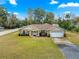Single-story home with stone accents and a three-car garage at 3707 Se 24Th St, Ocala, FL 34471