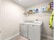 Bright laundry room with washer, dryer, and shelving at 3707 Se 24Th St, Ocala, FL 34471
