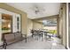 Screened porch features outdoor furniture and ceiling fan at 3707 Se 24Th St, Ocala, FL 34471