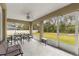Spacious screened porch with seating and outdoor dining at 3707 Se 24Th St, Ocala, FL 34471
